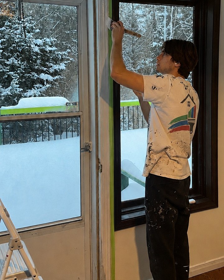 Stelmont Painting team member painting window trim and casing